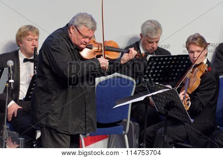ST. PETERSBURG, RUSSIA - DECEMBER 16, 2015: Violinist and conductor Sergey Stadler and the Symphony Orchestra of St. Petersburg play at the creative meeting during 4th St. Petersburg Cultural Forum
