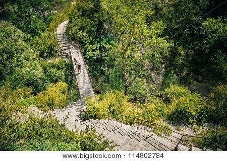 Tourists descend the steps to the mountain river Le Verdon in th