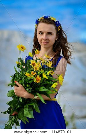 Portrait of Ukrainian, young, nice, smiling, bright girl, two traditional colors blue, yellow, meadow, bouquet of beautiful flowers, girl with flowers, woman, fashion, portrait, beauty, summer, nature, green, permed