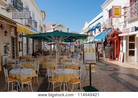 View to the pedestrian street with restaurants in Lagos, Portugal.