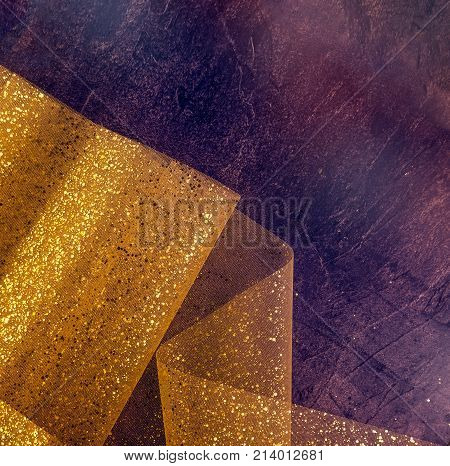 Gold Thread And Gliters On The Fabric Texture. Textile Roll With Waves And Wrinkles On The Dark Cosm