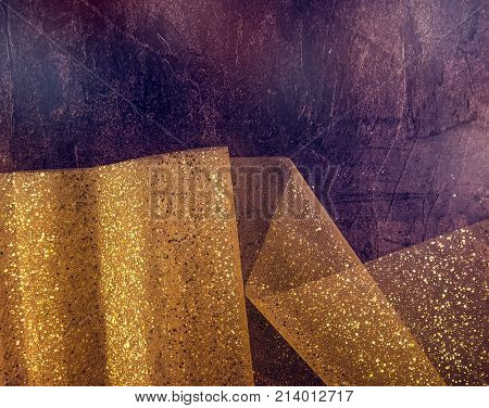 Gold Thread And Gliters On The Fabric Texture. Textile Roll With Waves And Wrinkles On The Dark Cosm