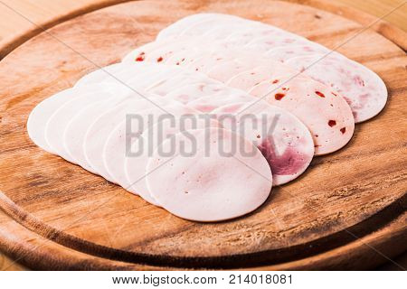 Meat delicatessen slaced  on a wooden board