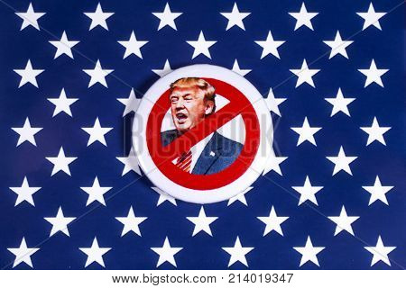 LONDON UK - NOVEMBER 15TH 2017: Anti-Tump badge over an American flag background on 15th November 2017.