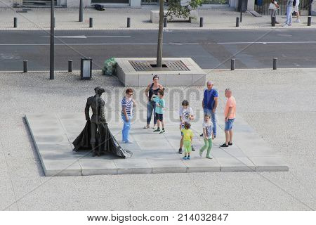 Nimes, Gard, France - Sep 02 2017: Family Of Tourists Gathered Round The Statue Of The Matador Chris