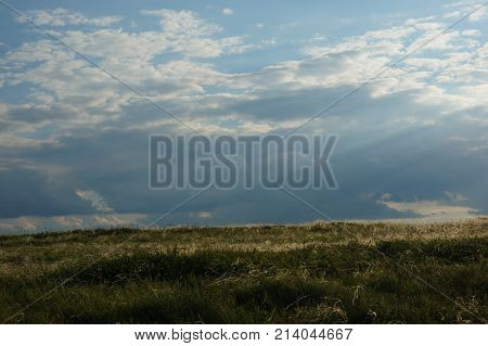 Landscape with summer steppe and cloudy sky