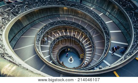VATICAN CITY - April 2017: Tourists walking down the spiral Bramante Staircase in the Vatican Museums