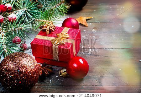 Red Christmas  Gift  Box With Red Ribbon And Fir Branches