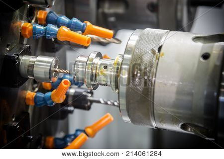 CNC lathe machine or Turning machine drilling the steel rod .Hi technology manufacturing process.