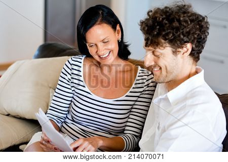Couple with papers in their living room