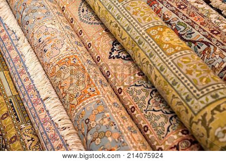 Variety of colorful Persian and Indian carpets on oriental bazaar