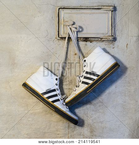 White Adidas Sneakers Hang On Laces