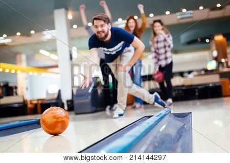 Friends having fun while bowling and speding time together