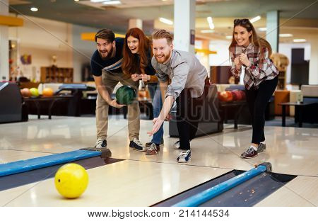 Friends having fun while bowling and speding time together