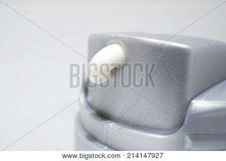Hand moisturizer cream on spender in the bath