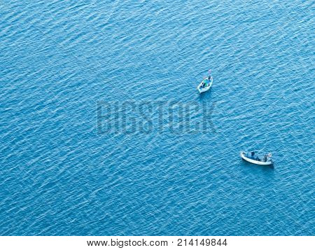 fishermen in boats in the open sea to catch fish. the view from the top