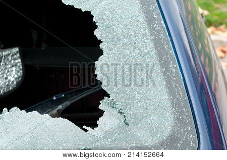Broken rear windshield glass on damaged car close up selective focus