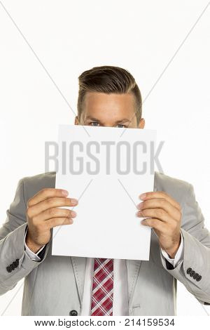manager holds blank sheet in front of face
