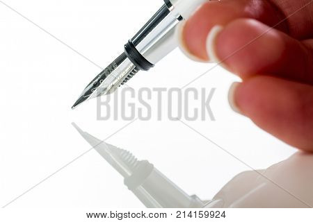 hand with fountain pen at signature