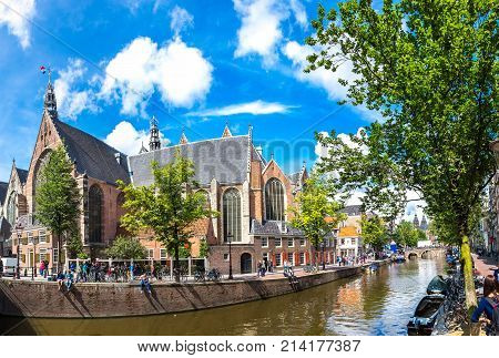 Oude Kerk (old Church) And Voorburgwal Canal In Amsterdam In A Summer Day