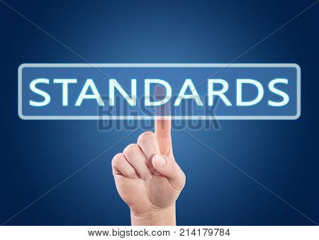 Hand pressing Standards button on interface with blue background.