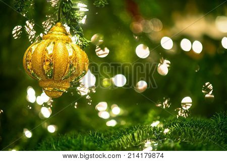 Christmas Background. Sparking Lights And Green With The Golden Ball In Focus On Side