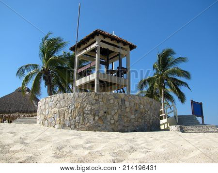guard post between the palm trees of the beach