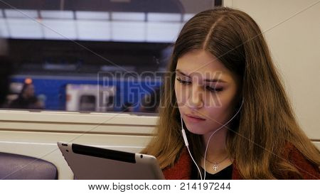 Young Businesswoman Traveling Train Tablet Computer. Young Woman In Subway Works In The Tablet.