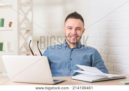 Portrait of smiling businessperson working on project in modern office. Occupation work online education and lifestyle concept.