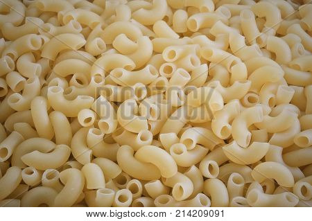 Food and Cuisine Background Textured of Uncooked and Dried Elbow Macaroni or Gomiti Pasta.