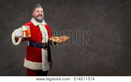 Santa with pizza and a glass of beer in his hands at Christmas on a background of copyspase.