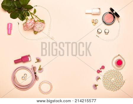 Fashionable Women's Cosmetics and Accessories. Falt Lay. Nail Polish and blush. Jewelry and Rings. A bouquet of flowers. Pink roses