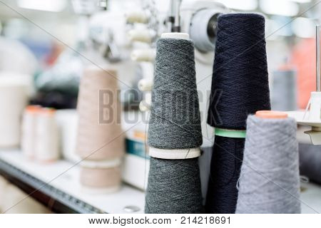 Wool and thread spools on desk used in textile industry