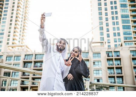 Arabic couple with traditional clothes dating outdoors