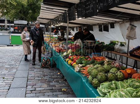 Paris France -- November 4 2017 -- Shoppers at a Parisan farmers market in Autumn. Editorial Use Only.