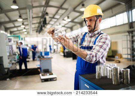 Supervisor doing quality control and pruduction check in metal factory