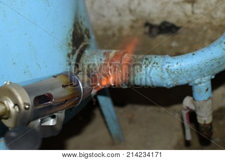 Heating A Steel Pipe With A Blowtorch. The Flame Of A Blowtorch