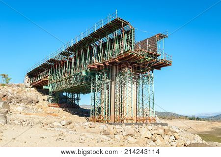 Arid terrain as a result of the drought with old and new bridge background in construction