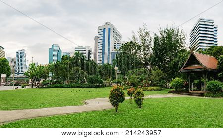 Bangkok, Thailand - December 23, 2015: Panorama view of Bangkok skyline from Lumphini Park, Thailand. Lumphini Park is a popular place for walks and sport activities in the heart of Bangkok.