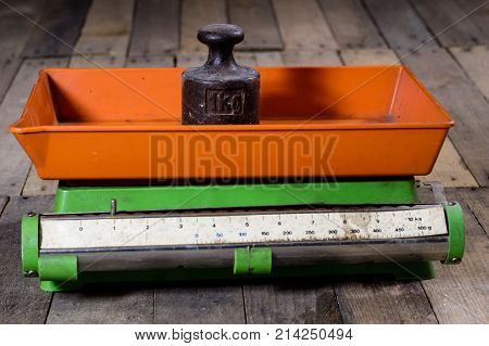 Old Weight And Weights On A Wooden Table. Old Used Kitchen Scale With Old Scale And Kilogram Weight