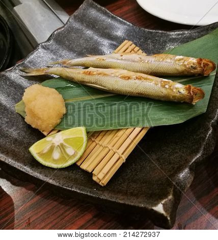 Sanma grilled Japanese egg fish served with green lime