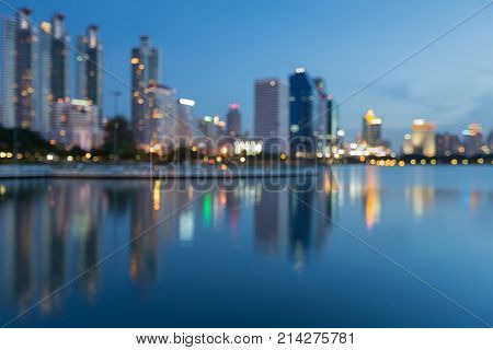 Blue twiligh office building with reflection blurred bokeh light abstract background