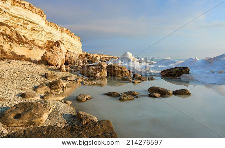 On the shore of the Caspian Sea. Caspian Sea in Kazakhstan.
The Caspian Sea is the largest enclosed inland body of water on Earth by area, variously classed as the world's largest lake or a full-fledged sea.