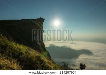 sunrise in the morning with light flare In the misty atmosphere surrounded by mountains place Phu Chi Fa Thailand