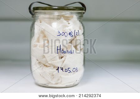 MOSCOW RUSSIA - June 24 2009. Glass jar with rags inside - sample of deadbody's blood. Shelves with material evidences in laboratory of examination human olfactory traces.