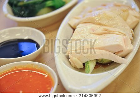 Delicious legendary Singaporean Hainanese chicken rice with two tones dipping sauce