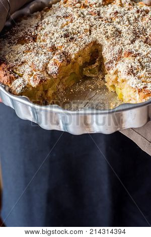 Man Chef Holding Baking Form with Homemade Vegan Eggless Apple Cake with Crumbles Cut out Slice. Natural Light Authentic Cozy Atmosphere. Fall Autumn Thanksgiving. Kinfolk Hygge