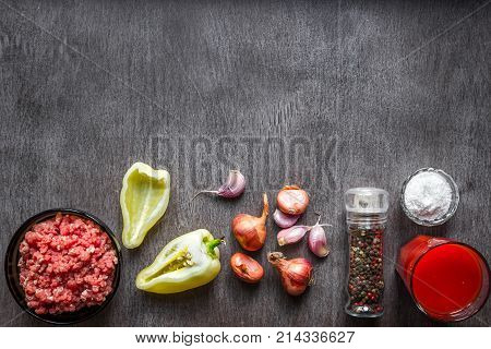 Composition of raw meat with vegetables and spice on wooden background. Top view. Copy space. Still life. Flat lay.