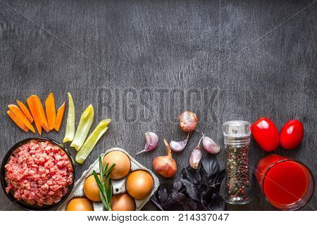 Composition of raw meat with vegetables and spice on wooden background. Top view. Copy space. Still life. Flat lay.