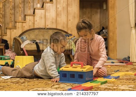 Brother and sister play in the children's room